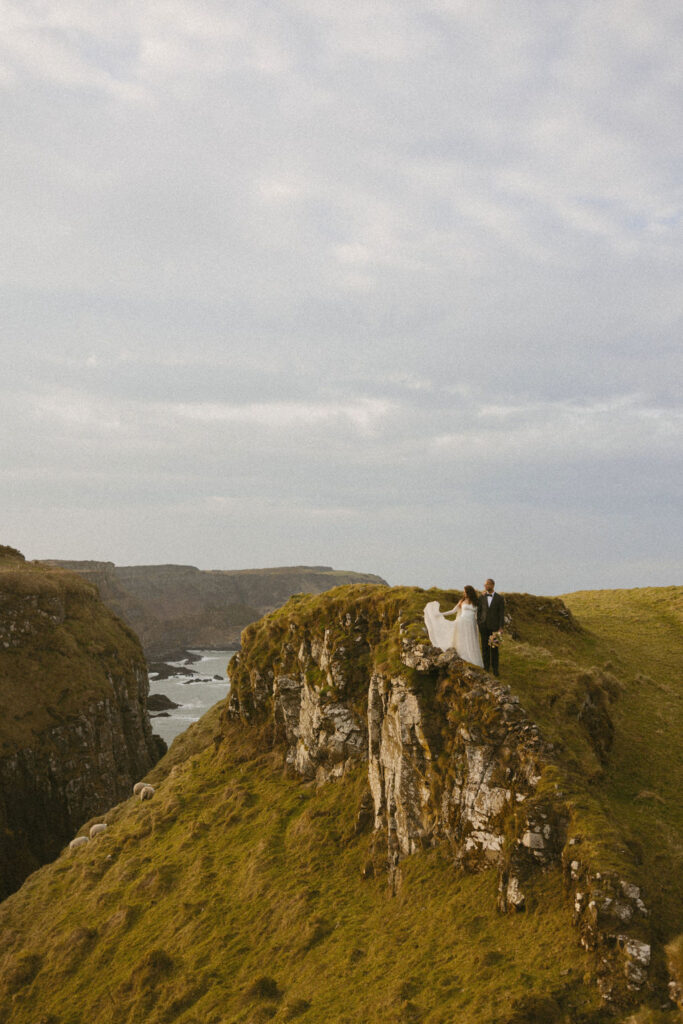 Couple embracing during Cliffs of Moher engagement session at sunset

Candid moment between engaged couple with wind-swept hair on Irish cliffs

True-to-life engagement photo at the edge of the Cliffs of Moher

Documentary-style engagement portrait in front of dramatic Irish landscape

Organic and natural engagement photography at iconic Cliffs of Moher

Laughing couple captured during authentic Cliffs of Moher photo session

Emotive engagement shoot with Atlantic Ocean backdrop in Ireland

Genuine moment from Cliffs of Moher engagement shoot in soft natural light